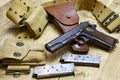 A still life of a 1911 pistol and accessories