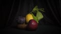 still life plum apple lemon dark still life vegetarian healthy food.