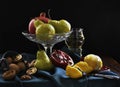 Still life with pomegranate, lemon, glass of wine, pear, walnut. Dark shadows, fruits in the style of Dutch artists