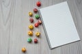 Still life of popcorn and a notepad are located on a wooden background. Top view.