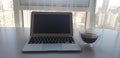 Still-life portrait of grey computer with black buttons, coffee mug on table Royalty Free Stock Photo