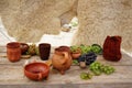 Still-life pottery grapes and fruit on a stone background Royalty Free Stock Photo