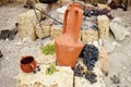 Still-life pottery grapes and fruit on a stone background Royalty Free Stock Photo