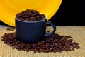 Coffee cup filled with coffee beans on dark background Royalty Free Stock Photo