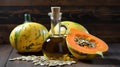 Still life with pumpkin seed oil in a glass carafe, pumpkin seeds and pumpkins as decortation on a wooden table Royalty Free Stock Photo