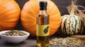 Still life with pumpkin seed oil in a glass carafe, pumpkin seeds and pumpkins as decortation on a wooden table