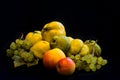 a still life with quinces, grapes, pears and apples and black background Royalty Free Stock Photo