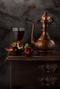 Still life with red wine, antique copper jug and apples Royalty Free Stock Photo