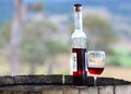 Still life red wine port bottle & glass on wood barrel Royalty Free Stock Photo