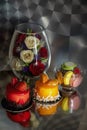 Still life with red and yellow caces, macarons and flowers Royalty Free Stock Photo