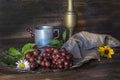 Still life with retro cup and vase and grapes.