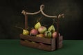 Still life with ripe apples and pears in a wooden box Royalty Free Stock Photo