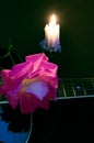 Still life with a rose guitar and a burning candle Royalty Free Stock Photo