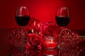 Still life with roses, red hearts and two glasses with wine on red background. Valentine`s Day card Royalty Free Stock Photo