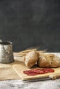 a still life with rye bread rolls, salami slices Royalty Free Stock Photo