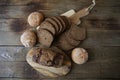 Still life with rye bread with sesame seeds and buns white bread on a wooden rustic background, top view, flat lay