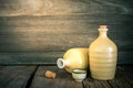 Still life of sake bottles with light on wood background. Royalty Free Stock Photo