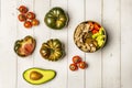 A still life with salad with various types of diced tomato, avocado and lots of canned tuna, sweet marmalade tomatoes, half an