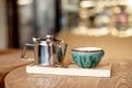 Still life set with cup of tea, teapot and tray on a wooden table in cafe interior Royalty Free Stock Photo