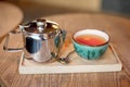 Still life set with cup of tea, teapot and tray on a wooden table in cafe interior Royalty Free Stock Photo