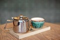 Still life set with cup of tea, teapot and tray on a wooden table in cafe interior Royalty Free Stock Photo