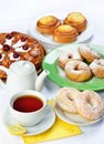 Still life of setout table with baking pies, donuts, tee cup and Royalty Free Stock Photo