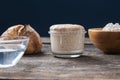 Still life setting with jar of sourdough starter yeast and bread ingredients