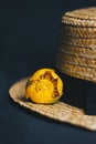 Bouquet of yellow waterlily flower with green leaf. freshly ripped up. In a straw hat. close up on black background of fabric. Royalty Free Stock Photo