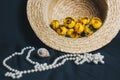 Bouquet of yellow waterlily flower with green leaf. freshly ripped up. In a straw hat. close up on black background of fabric. Royalty Free Stock Photo