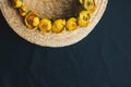 Bouquet of yellow waterlily flower with green leaf. freshly ripped up. In a straw hat. close up on black background of fabric. Royalty Free Stock Photo