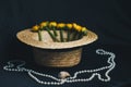 Bouquet of yellow waterlily flower with green leaf. freshly ripped up. In a straw hat. close up on black background of fabric. Royalty Free Stock Photo