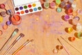 Still life, showing an interest in watercolor painting and art. A lot of brushes, jars with watercolor paint and used gouache lie Royalty Free Stock Photo