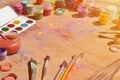 Still life, showing an interest in watercolor painting and art. A lot of brushes, jars with watercolor paint and used gouache lie Royalty Free Stock Photo