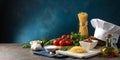 Still life of pasta ingredients with tomatoes, garlic, and chef\'s hat on a table Royalty Free Stock Photo