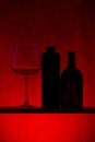 Still life with silhouettes of bottles and wine glass Royalty Free Stock Photo