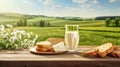 Still life with slices of bread, cheese and milk in glass, green summer landscape with fields in the background