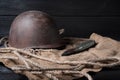 Still life soviet helmet and large-caliber cartridge on a black background Royalty Free Stock Photo