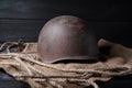 Still life soviet helmet and large-caliber cartridge on a black background Royalty Free Stock Photo