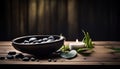 Still life spa composition with stones, green leaf and burning aromatic candle on a wooden table Royalty Free Stock Photo