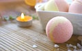 Still life spa resort treatment with bath bombs and candle on wooden background.