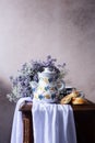 Still life with a Spanish-style coffee pot and purple flowers Royalty Free Stock Photo