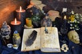 Still life with spell book, magic jars with plants and potion on witch table Royalty Free Stock Photo