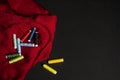 Still life with spools of multi-colored thread on a folded subtle red cloth cloth on a black surface Royalty Free Stock Photo