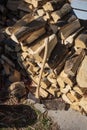 Wood pile and axe along the side of a shed Royalty Free Stock Photo