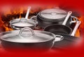 Still life of steel pots with flames and red background. Royalty Free Stock Photo