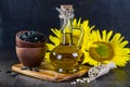 Still life with sunflower oil in glass bottle, seed and sunflower Royalty Free Stock Photo