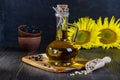 Still life with sunflower oil in glass bottle, seed and sunflower Royalty Free Stock Photo