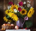 Still life with sunflowers, apples and plums Royalty Free Stock Photo