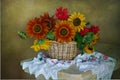 Still life with sunflowers in a basket with embroidered flowers on a towel Royalty Free Stock Photo