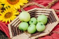 Still life sunflowers and green apples in a basket. Royalty Free Stock Photo